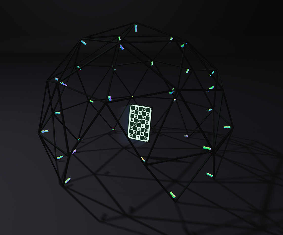 Geodesic dome structure with colorful cylindrical attachments and a black and white calibration chessboard inside.
