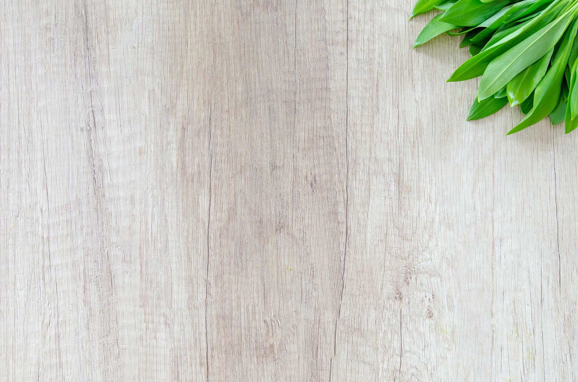 A background image of wood and a bunch of leaves
