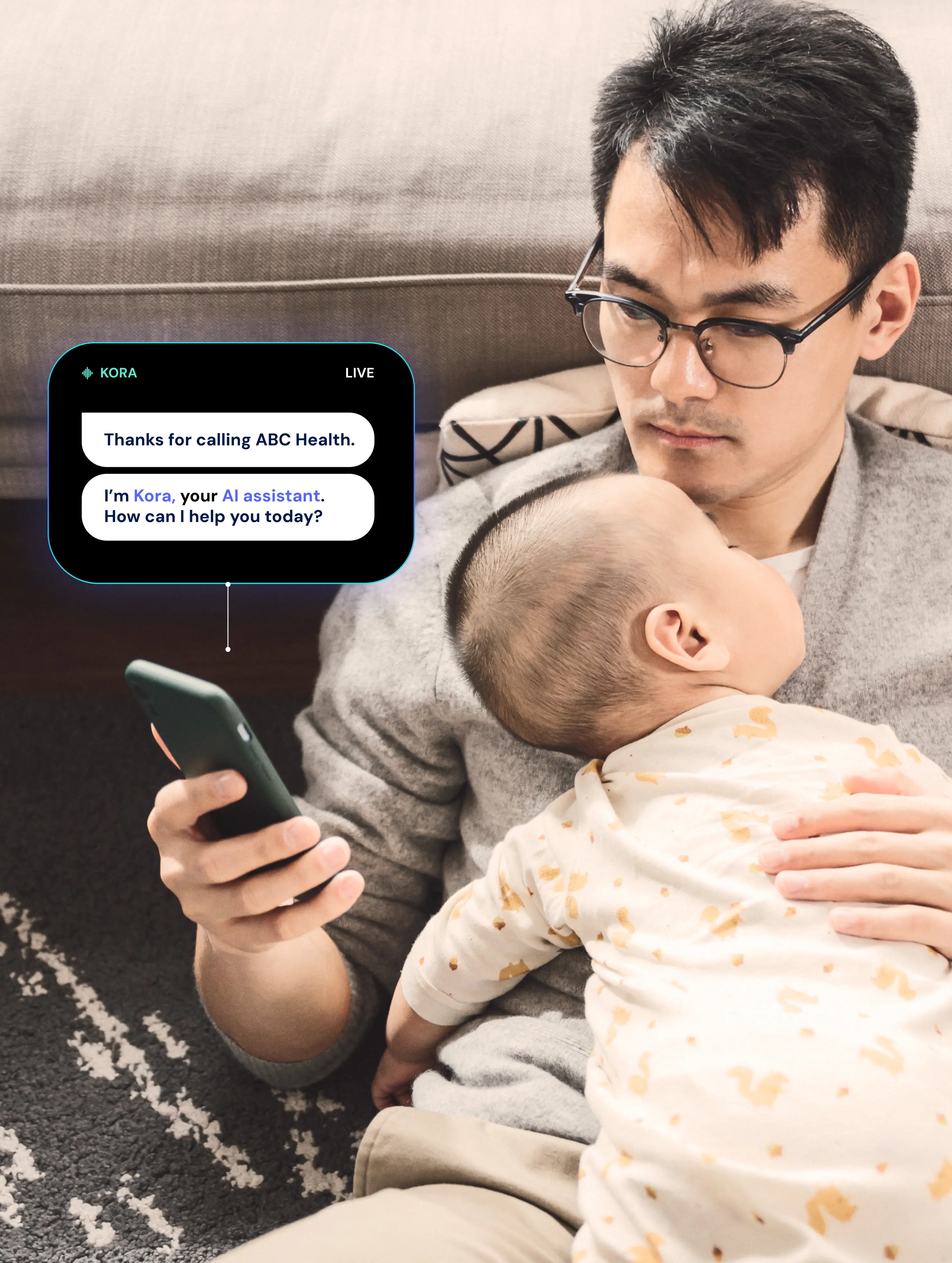 Man wearing glasses holding a baby wrapped in a patterned blanket while looking at a smartphone with a virtual AI assistant message displayed.