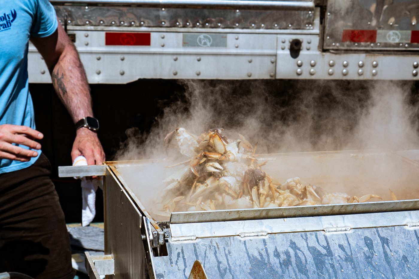 A cook lifting steaming crab from the cooker at BC CrabFest 2026