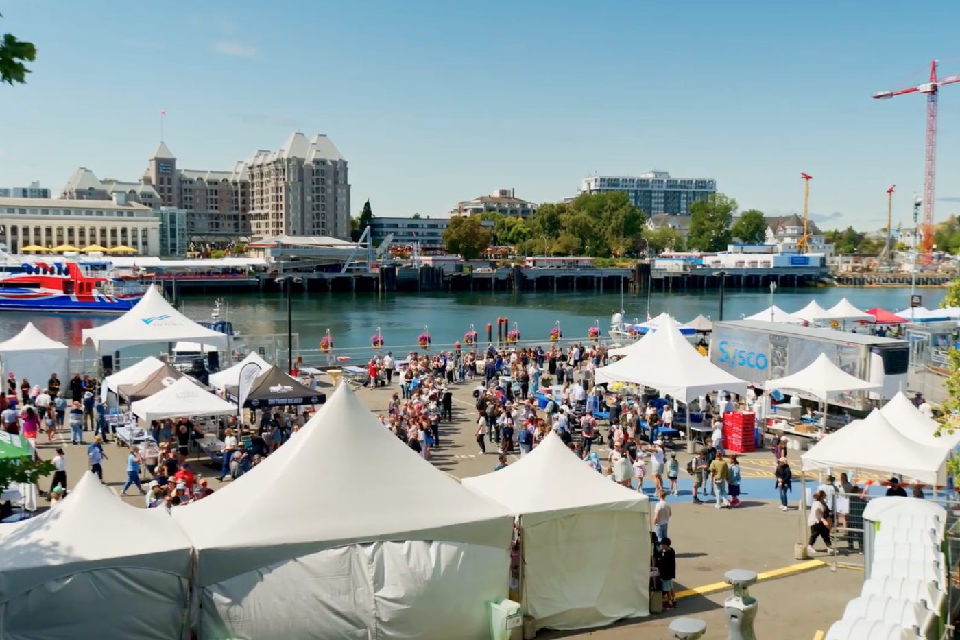 Crowds and white event tents at Ship Point, Victoria, during BC CrabFest 2026