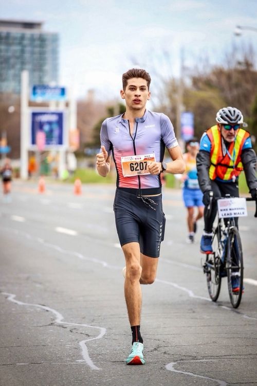 image of passengers boarding a bus at a city bus station
