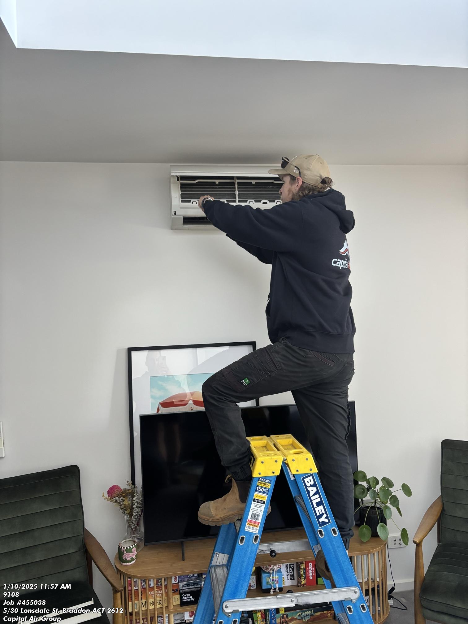 Split system air conditioning maintenance by Capital Air technician.