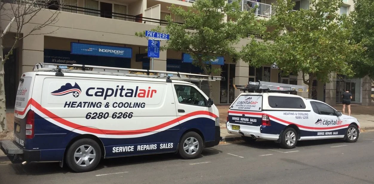 Two Capital Air heating and cooling service vehicles.