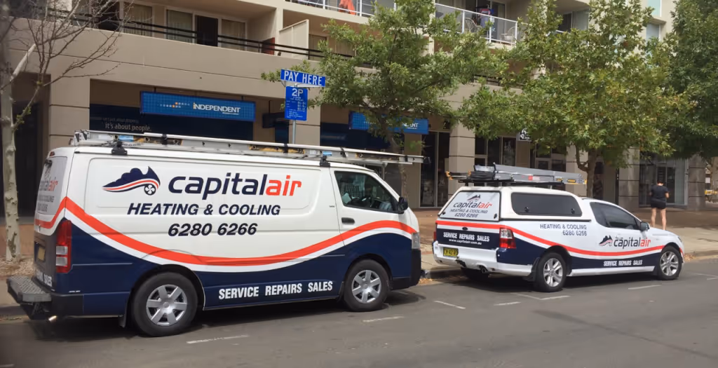 Capital Air service vehicles parked outside residential apartments in Canberra.