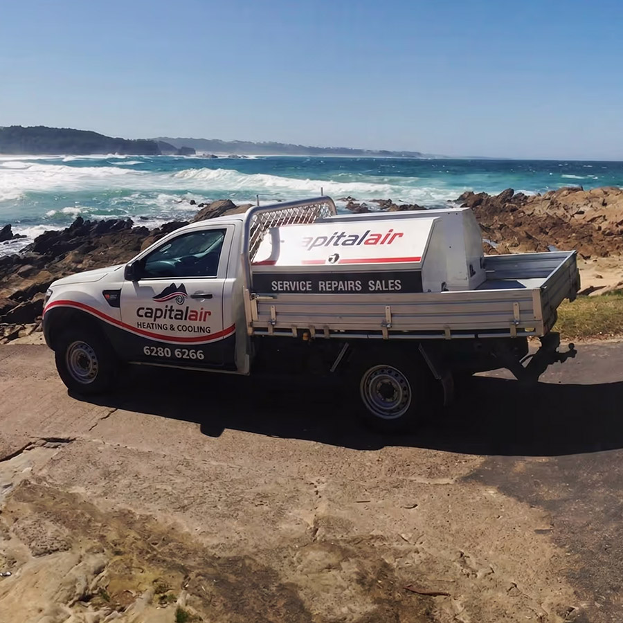 Capital Air service vehicle parked near coastal work site during installation job.