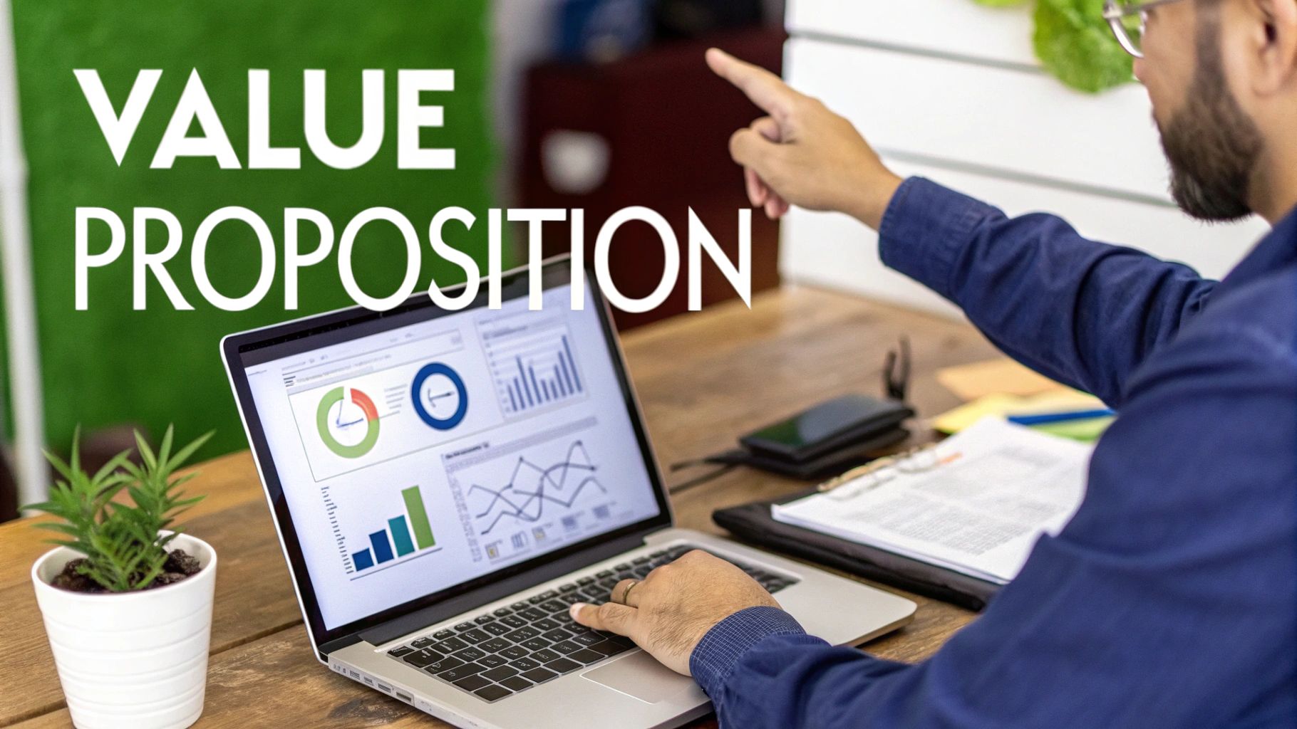 Man pointing at a laptop screen showing business graphs, with 'VALUE PROPOSITION' text on green wall.