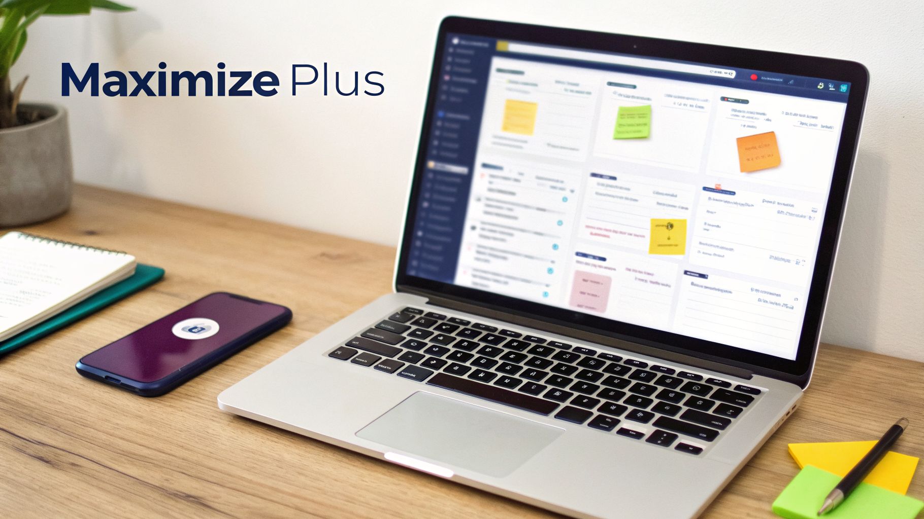 A modern workspace setup with a laptop showing a business dashboard, smartphone, and notebook.