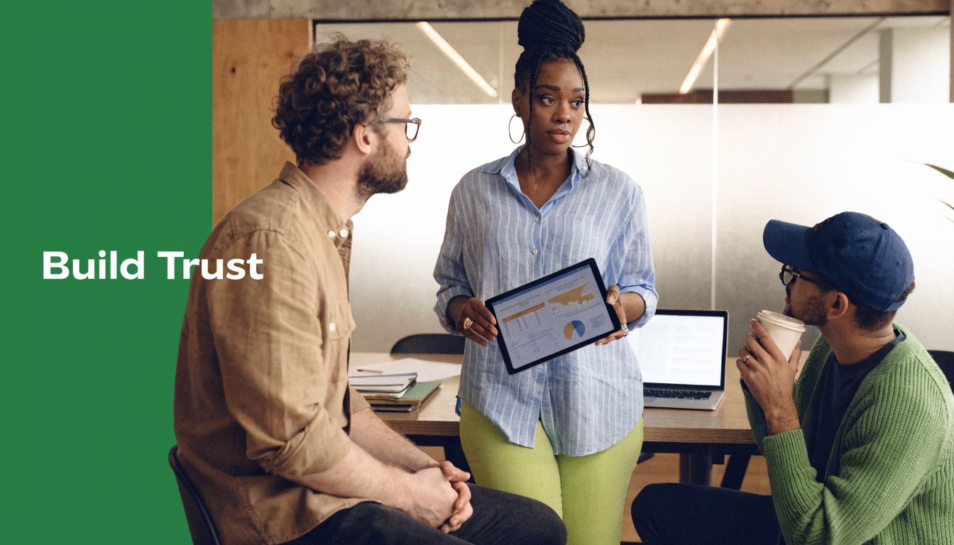 A professional woman presenting data on a tablet to two colleagues during a collaborative office meeting.