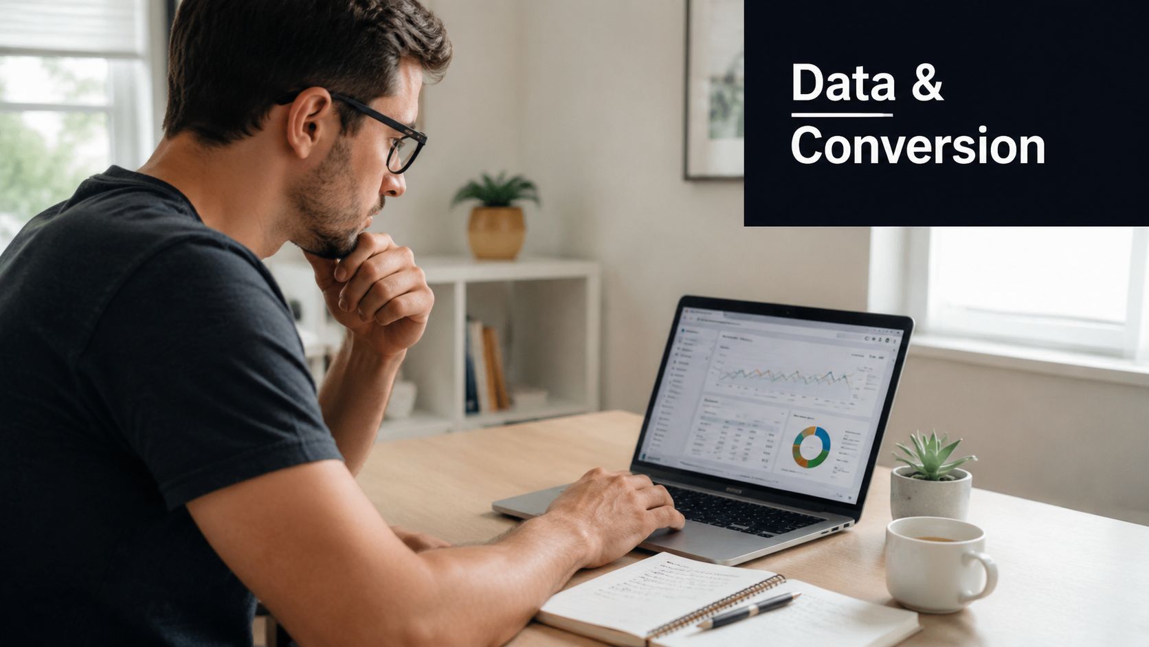 A professional man with glasses sitting at a desk and analyzing website conversion data on a laptop.