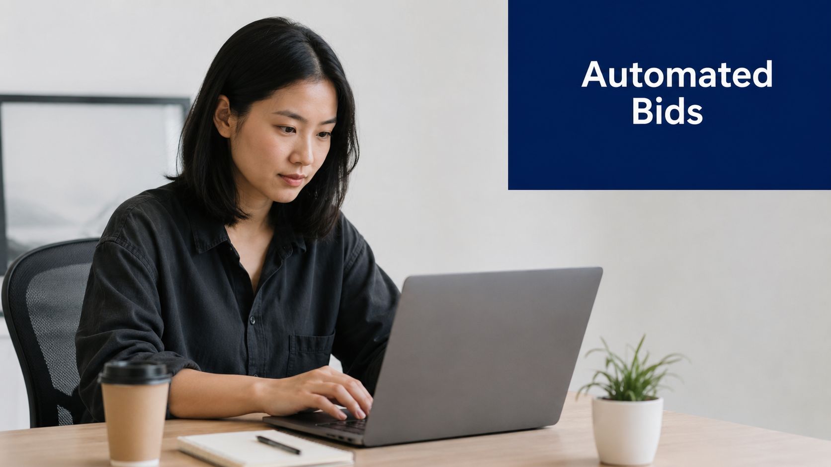A woman working on a laptop at a desk with the text Automated Bids above her.