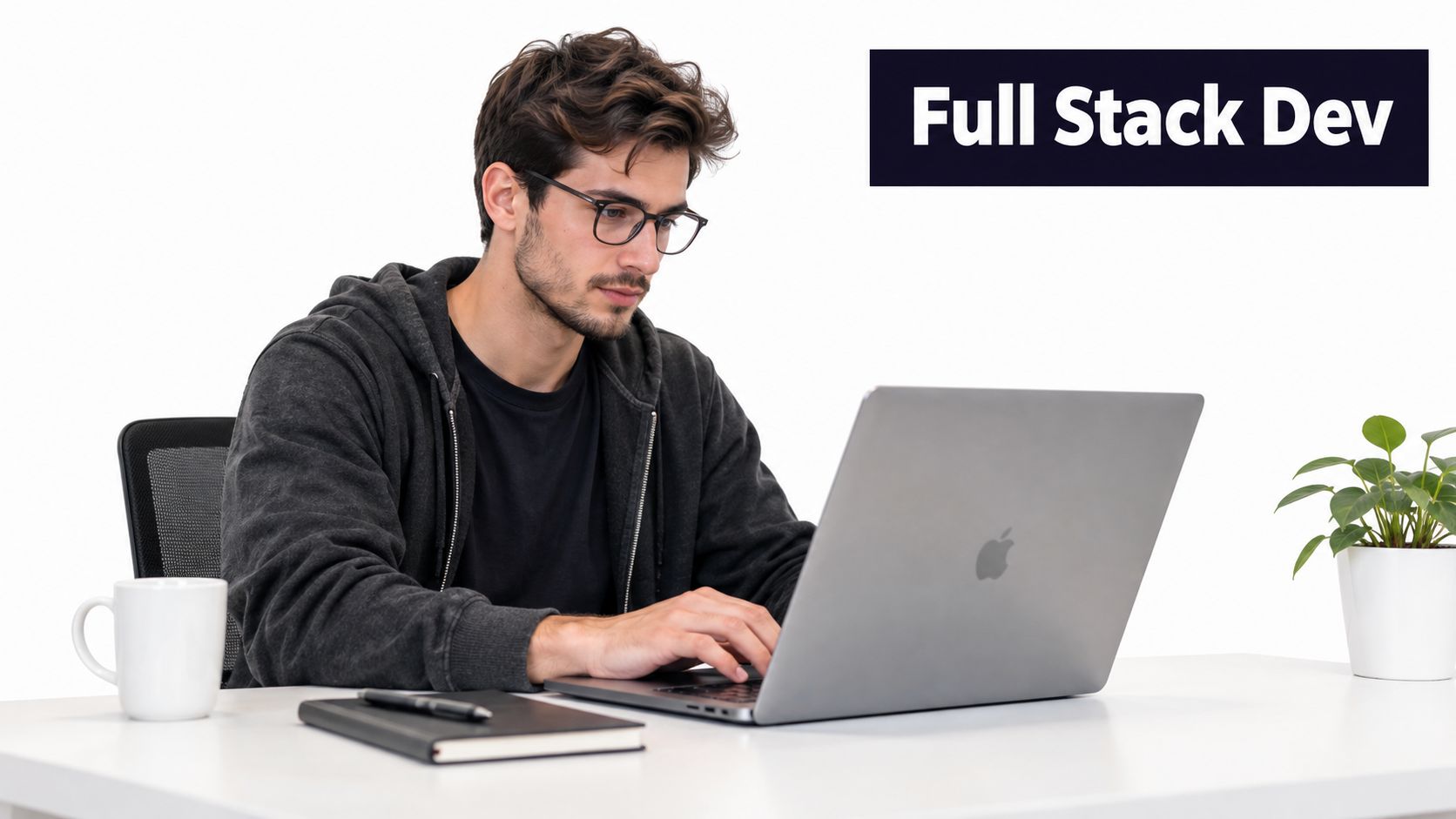 A professional developer working on a laptop at a clean office desk with a coffee mug.