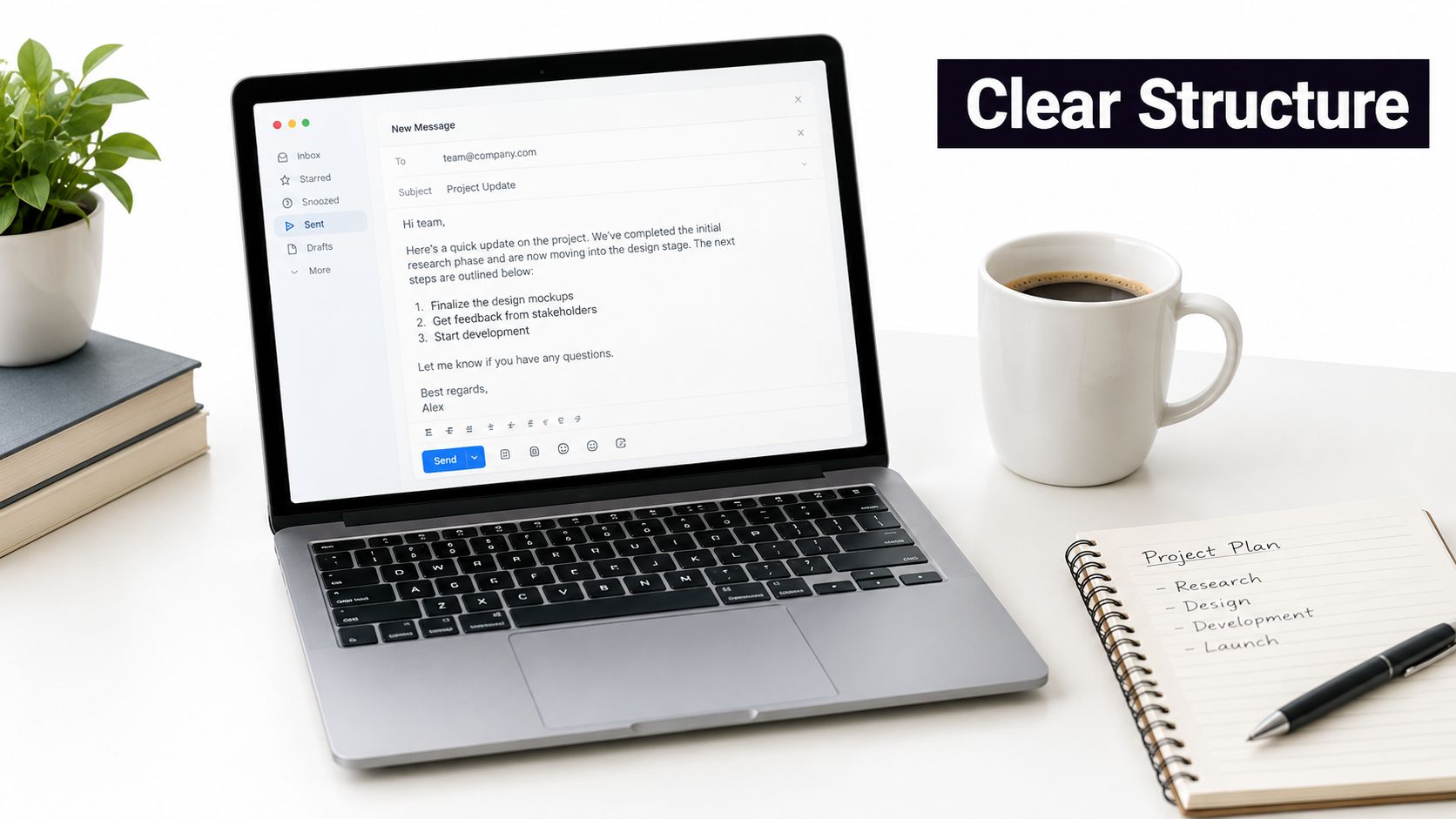A laptop displaying a professional email draft next to a notebook with a written project plan.