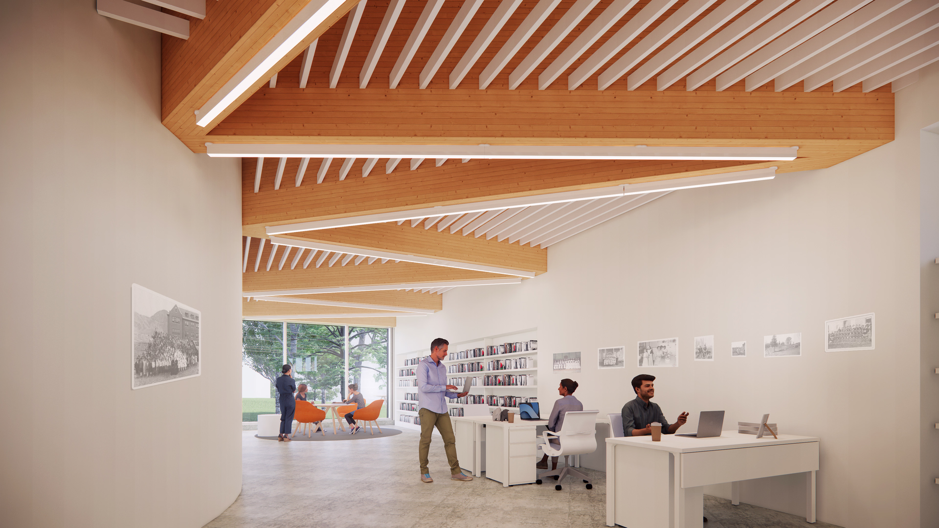 Modern office space with wooden ceiling beams, people working at desks with laptops, and a seating area by large windows.
