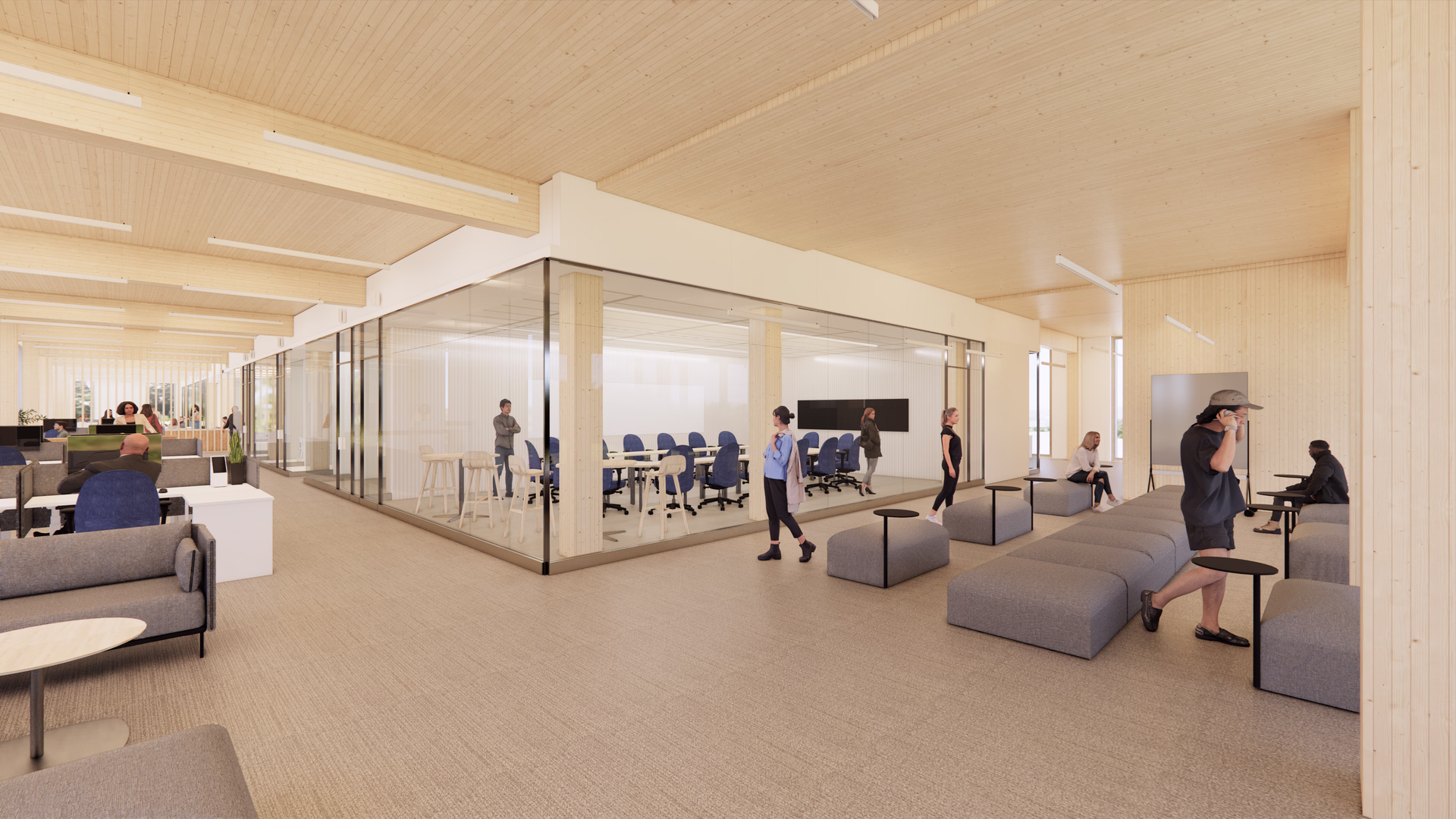 Modern office interior featuring an open workspace with desks and chairs on the left, a glass-walled conference room in the center, and a casual seating area with gray benches and small tables on the right where people are interacting.