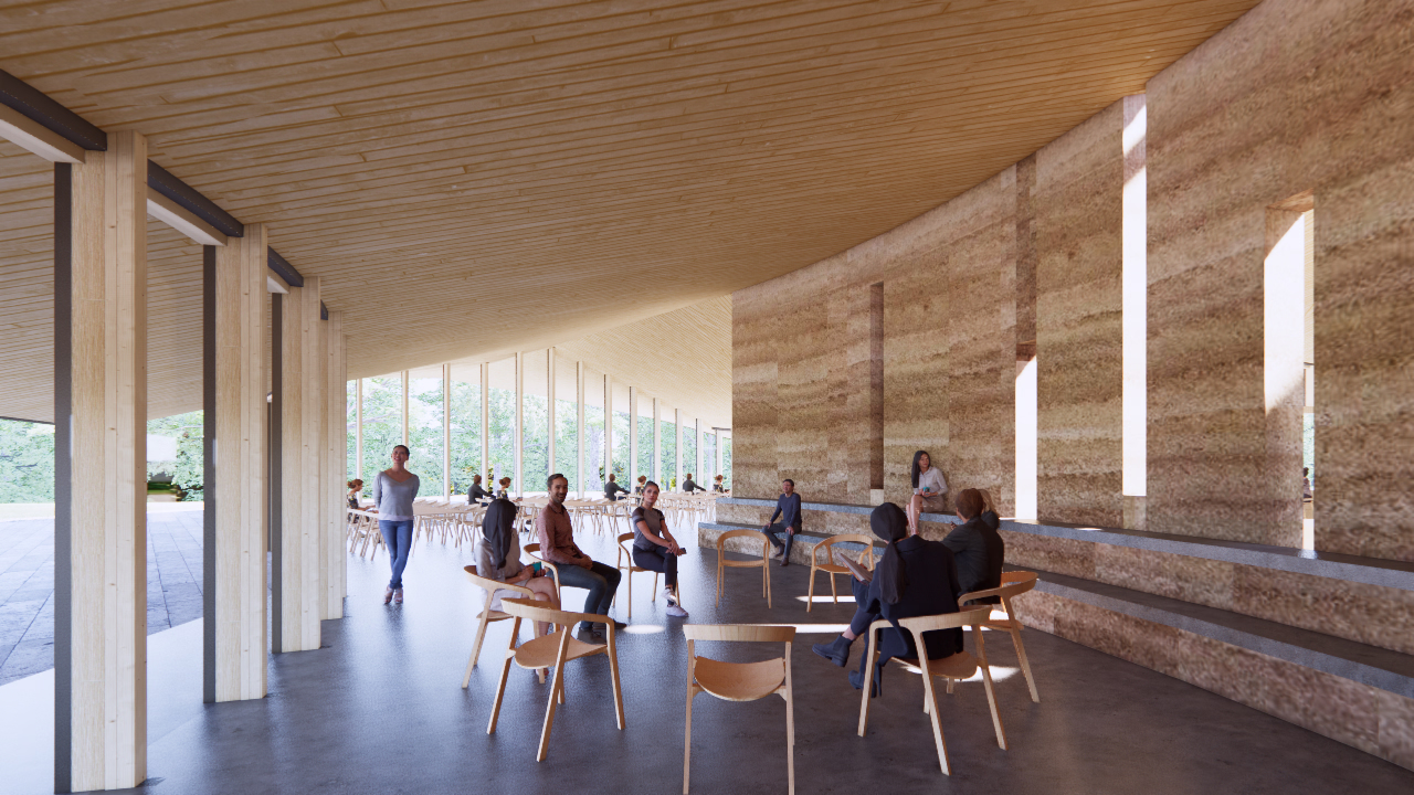 Modern indoor space with wooden ceiling and large windows, people sitting and talking on wooden chairs arranged in a circle.