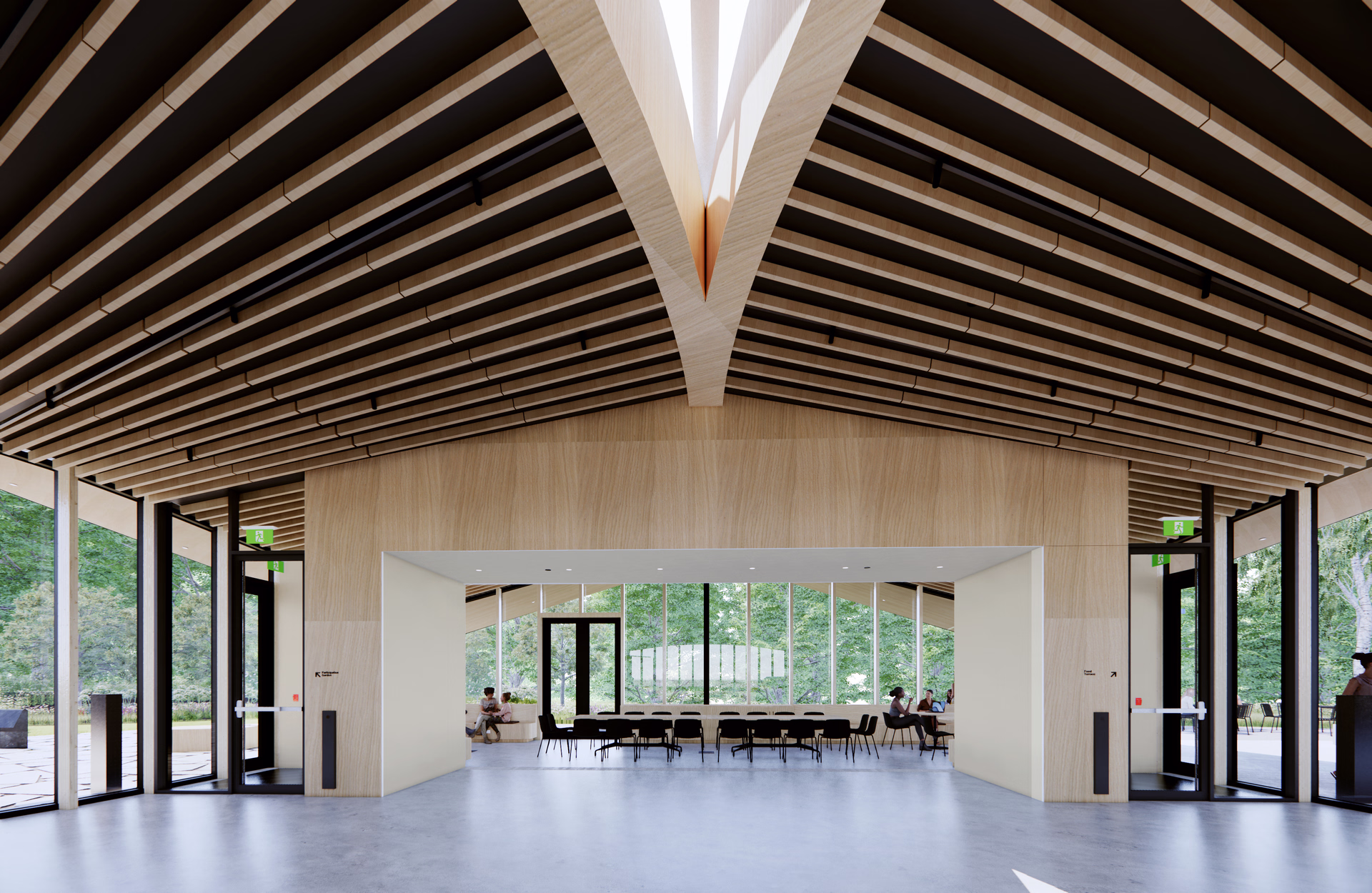 Modern interior with high wooden ceiling, large windows overlooking trees, and a seating area with tables and chairs.