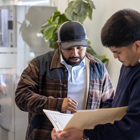 An advisor helping roofer with insurance policy.
