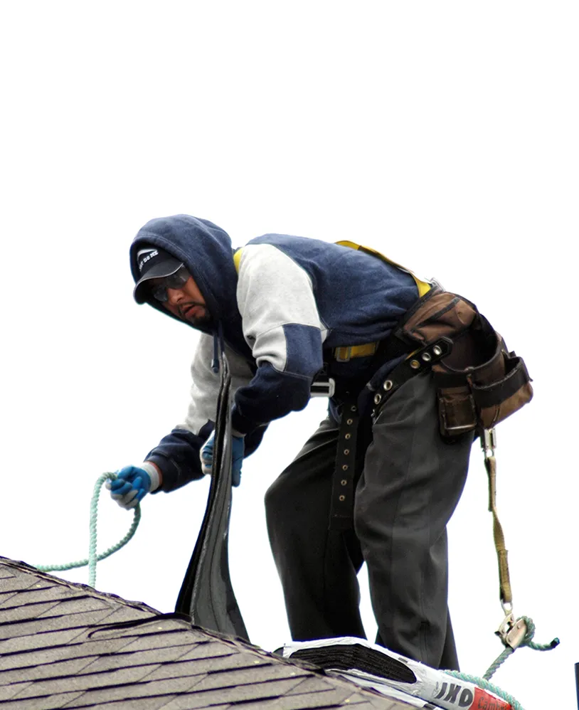 Roofer installing shingles.