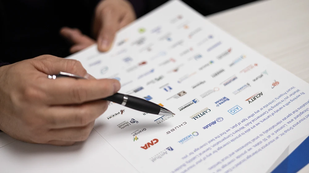 Pointing at insurance carriers on paper