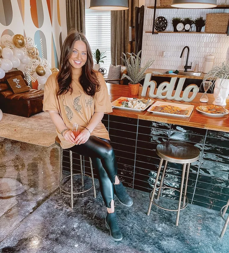 girl sitting at bar in community kitchen