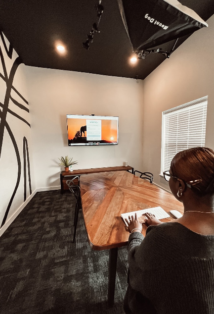 girl sitting at table in podcast room