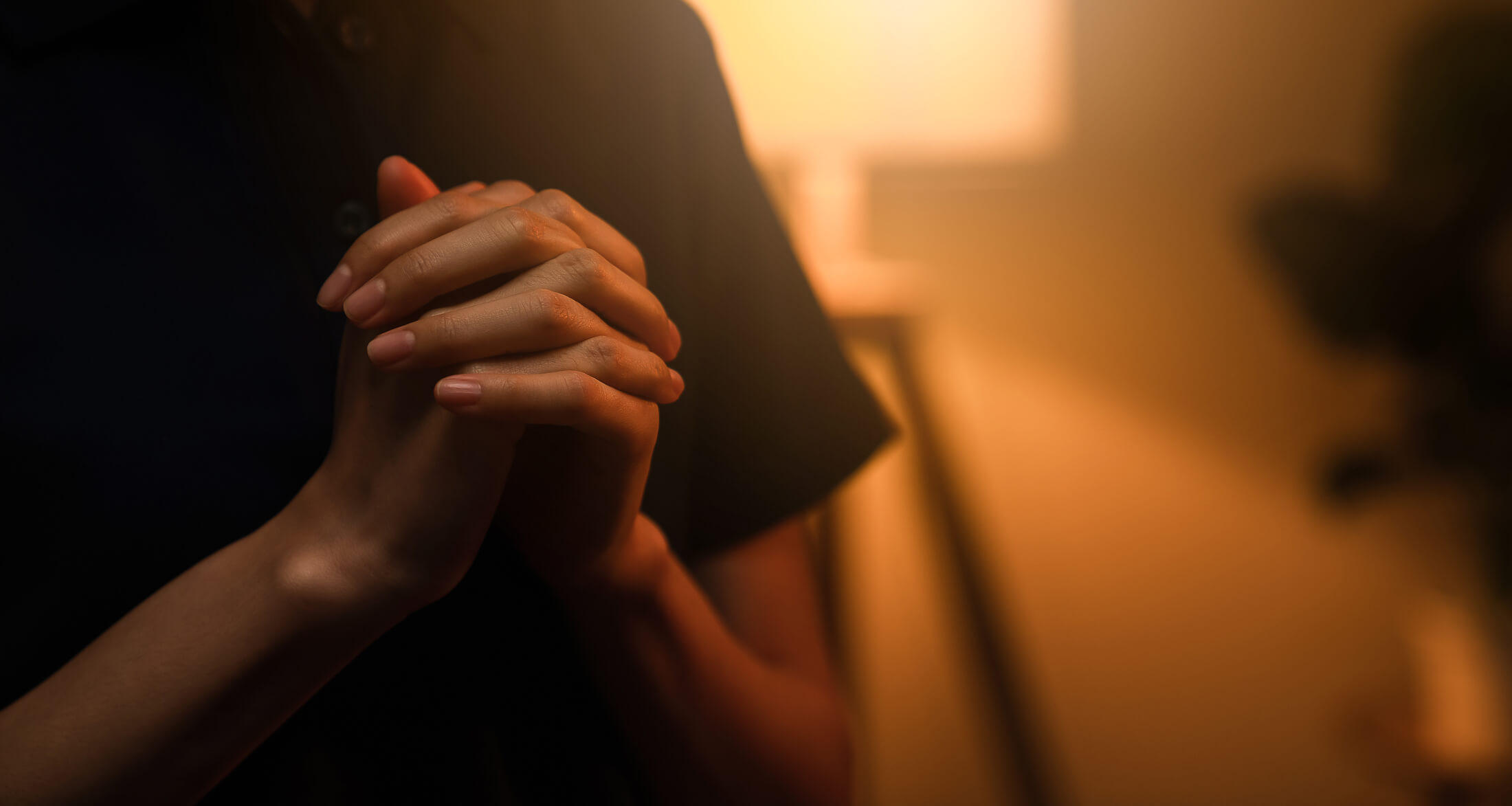 A close up photograph of folder hands praying