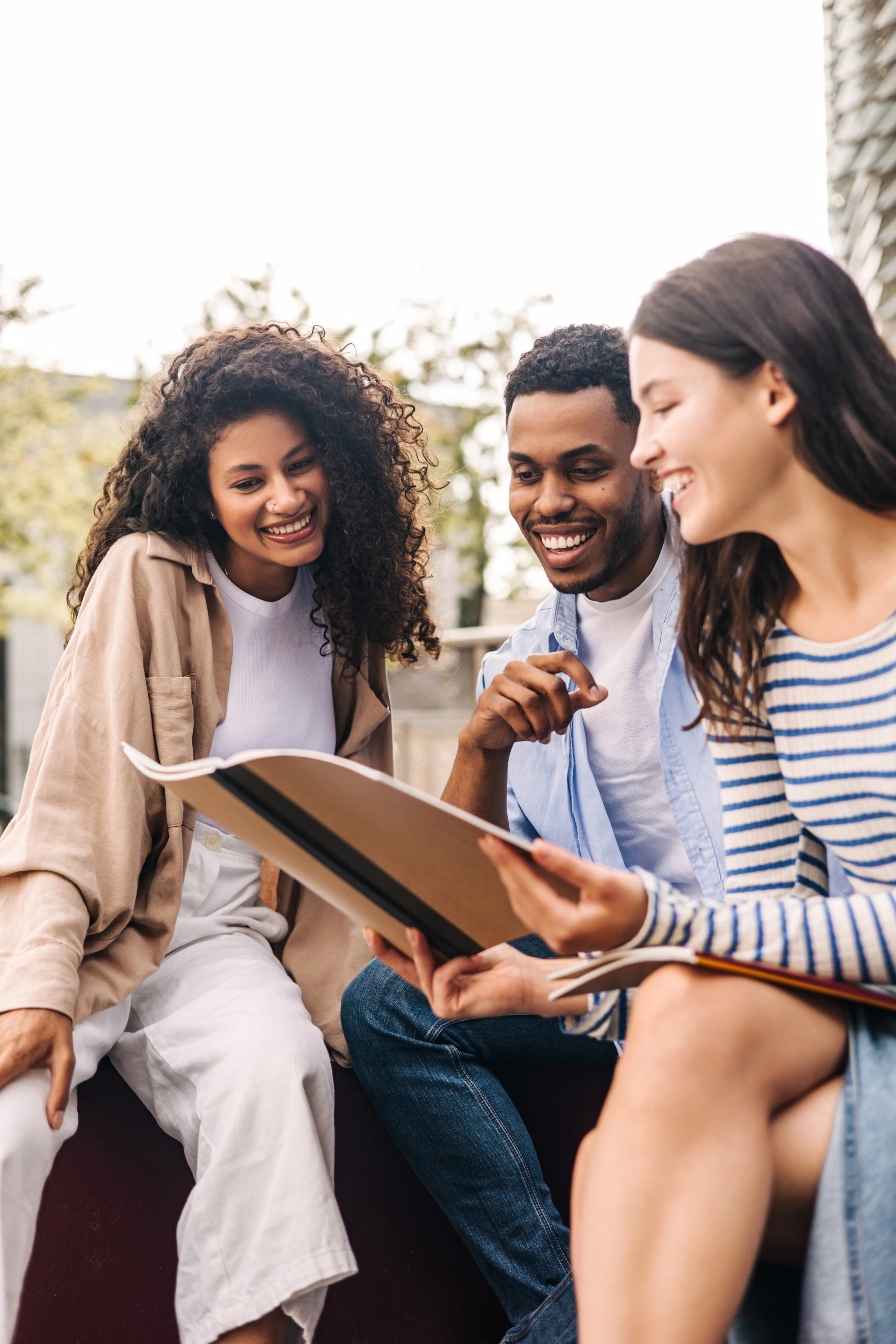 Students looking at a book stock image