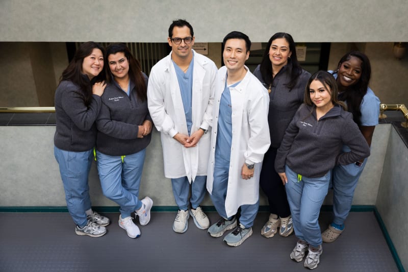 Dental team group photo with doctors and staff in white coats