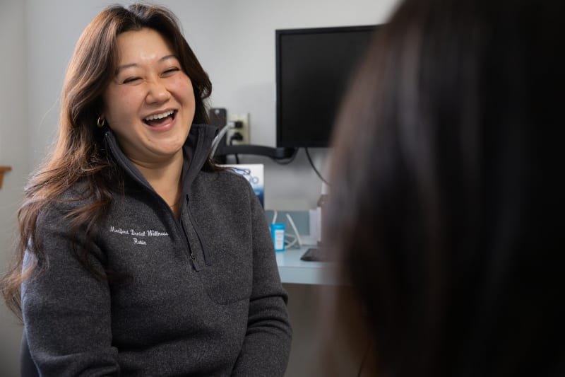 Receptionist speaking to patient at Medford Dental Wellness