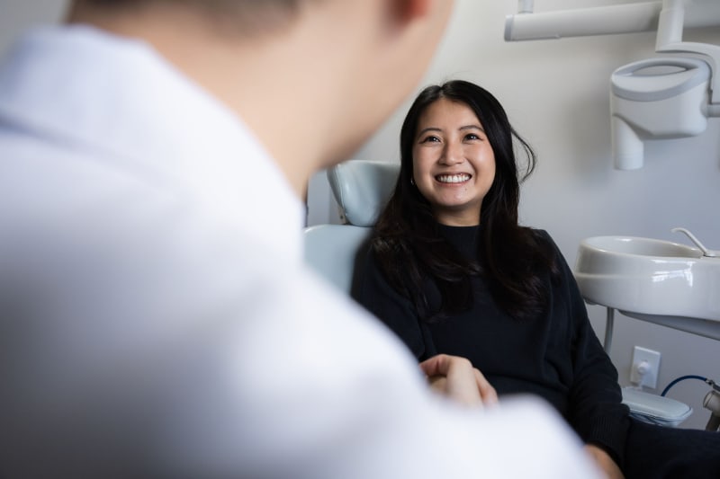 Dentist in professional consultation with patient in treatment room