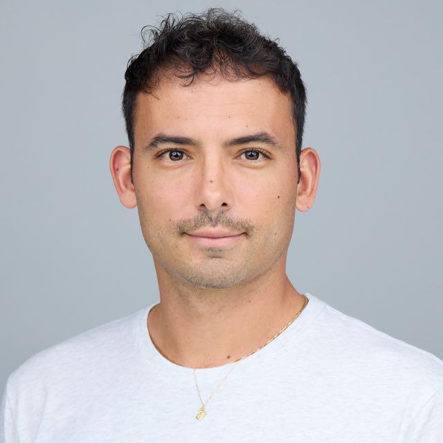 Generic user profile icon with a circle for the head and a curved line for shoulders on a beige background.