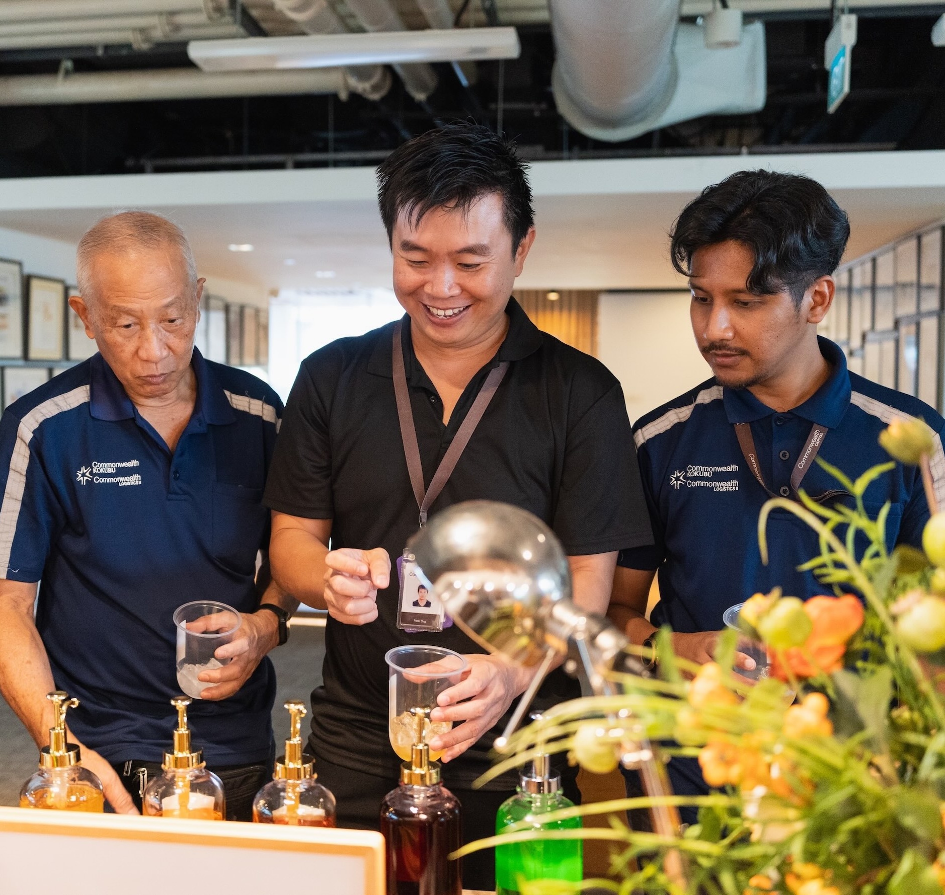 Three men, looking curious while interacting with an Arteasan live station