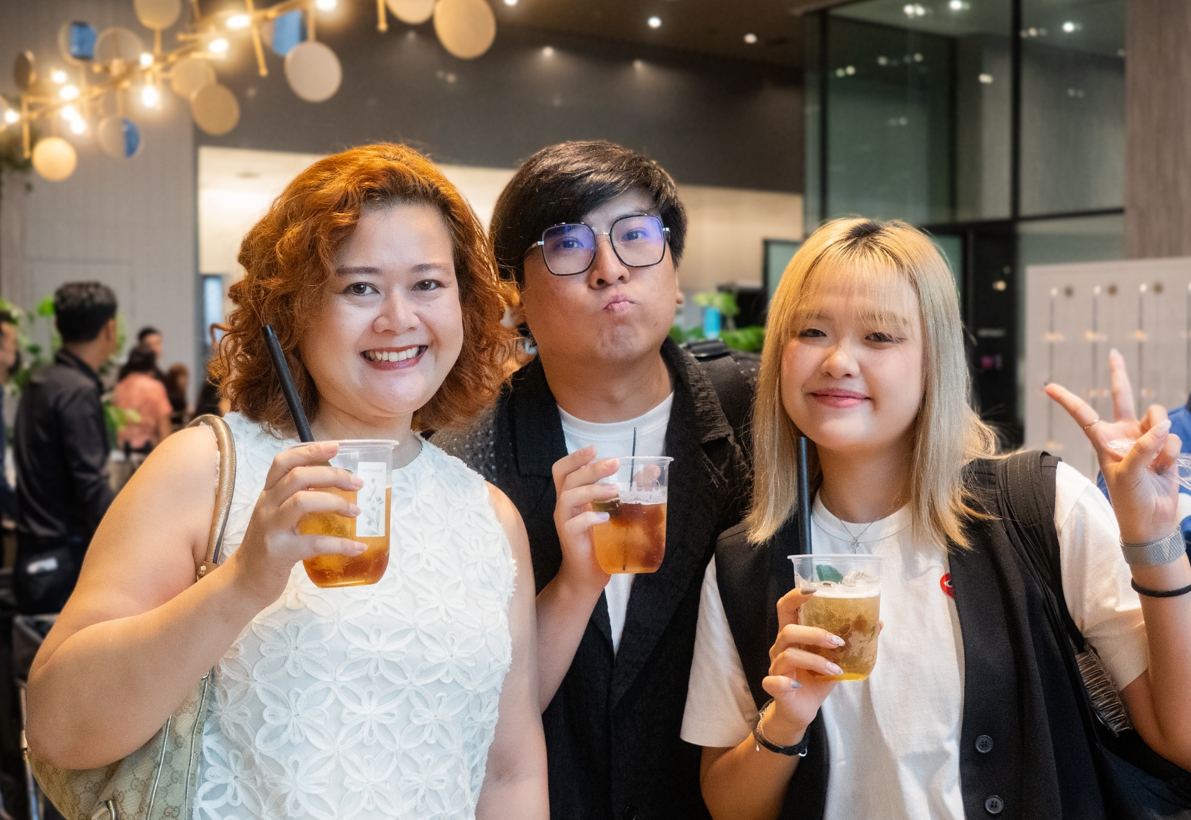 One men and two women holding an Arteasan cup, posing for the camera