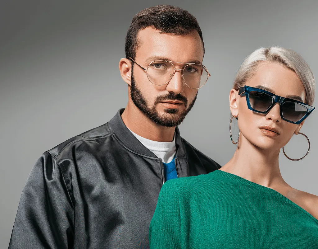 Couple modeling designer eyewear including aviator prescription glasses and blue sunglasses