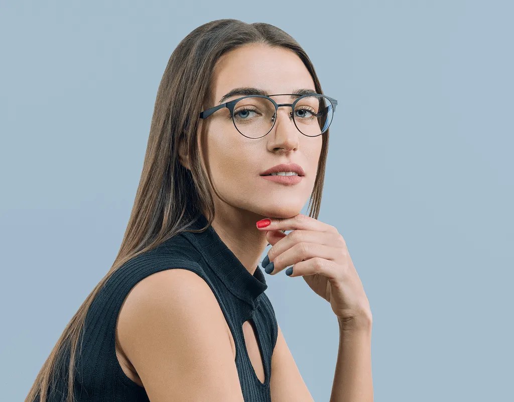 Woman modeling blue clubmaster prescription eyeglass frames from independent opticians