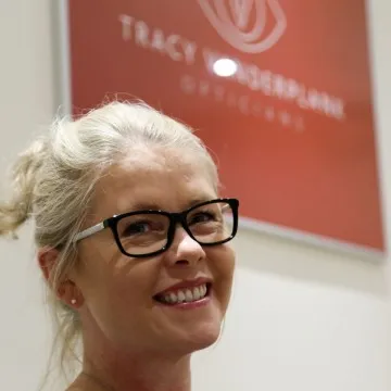 Friendly optometry team member smiling inside a professional eye care practice