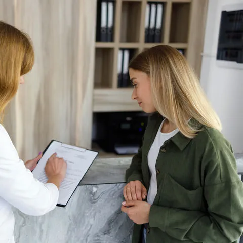 Optometrist consulting with patient during private eye examination appointment