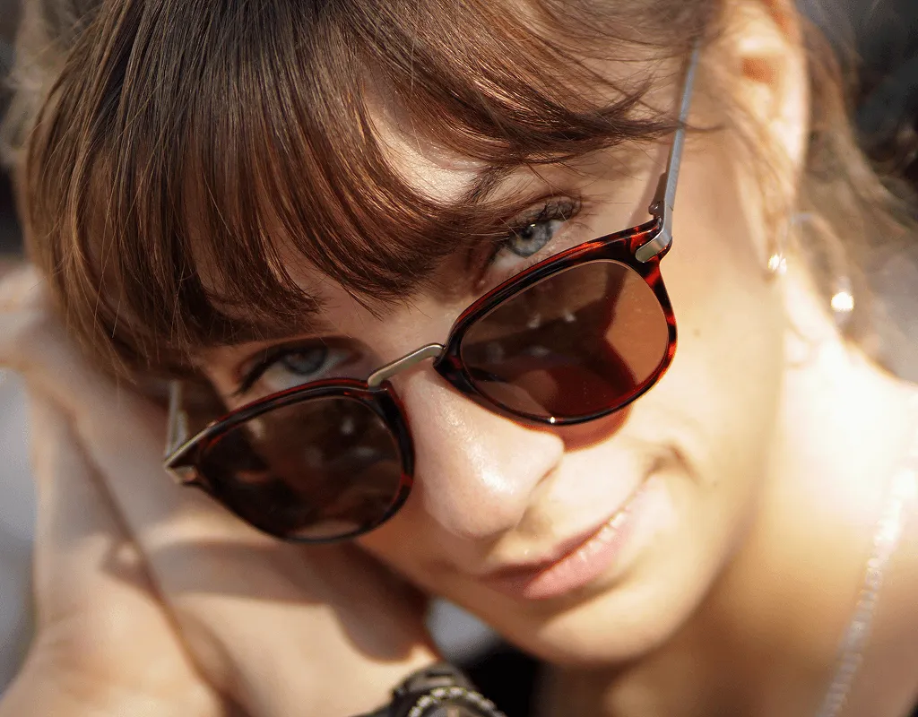 Optician fitting round prescription eyeglass frames ensuring proper comfort and vision