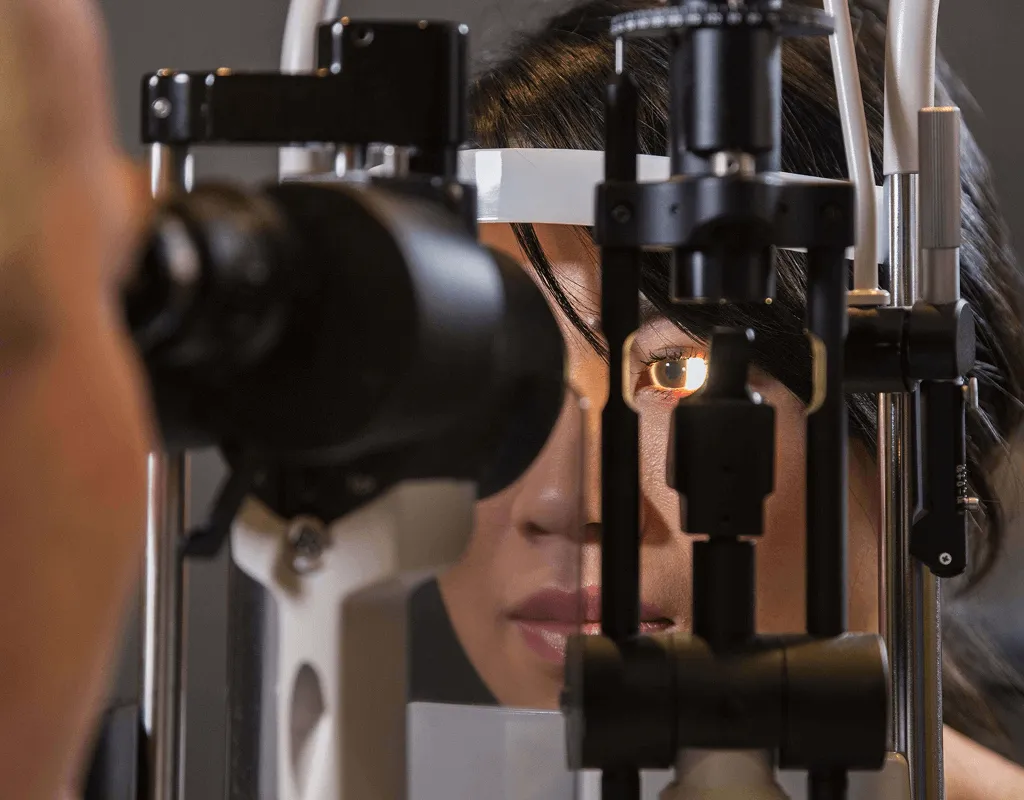 Patient receiving professional slit lamp eye examination at optometry clinic