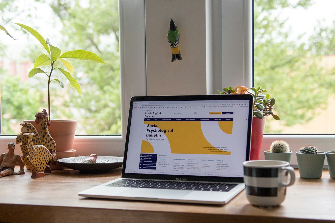 Laptop showing mortgage options on a desk with plants
