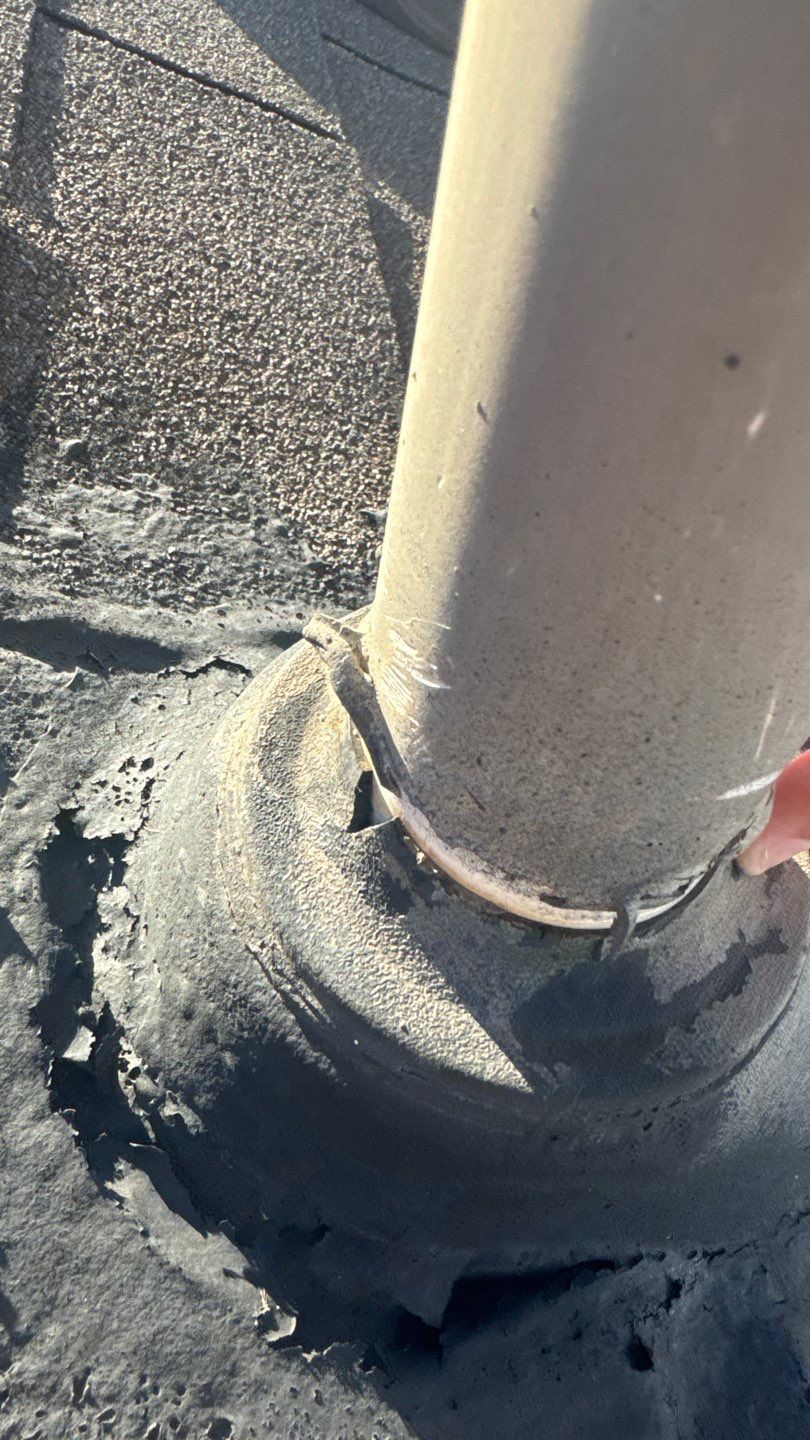 Close-up of a split pipe boot collar letting water into the roof