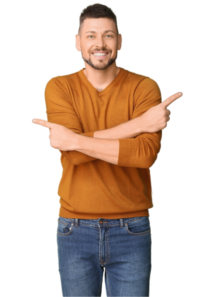 Smiling man in an orange sweater and jeans pointing both hands in opposite directions.