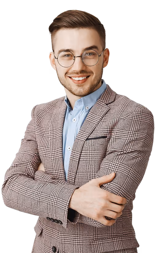 Smiling young man wearing round glasses, a blue shirt, and a checked blazer with arms crossed.