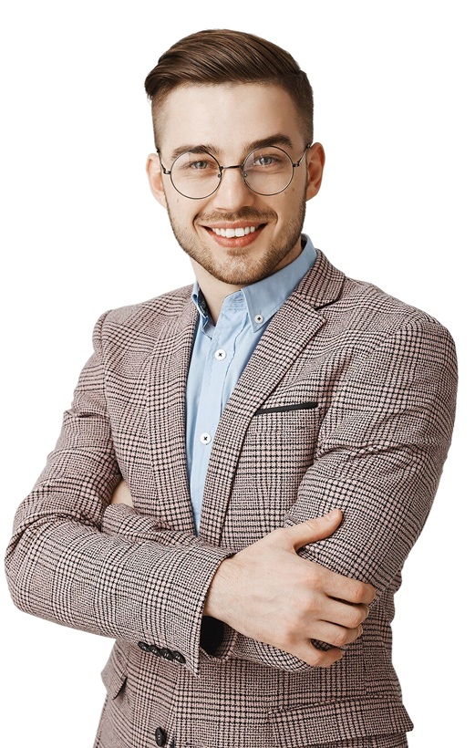 Smiling young man wearing round glasses, a blue shirt, and a checked blazer with arms crossed.