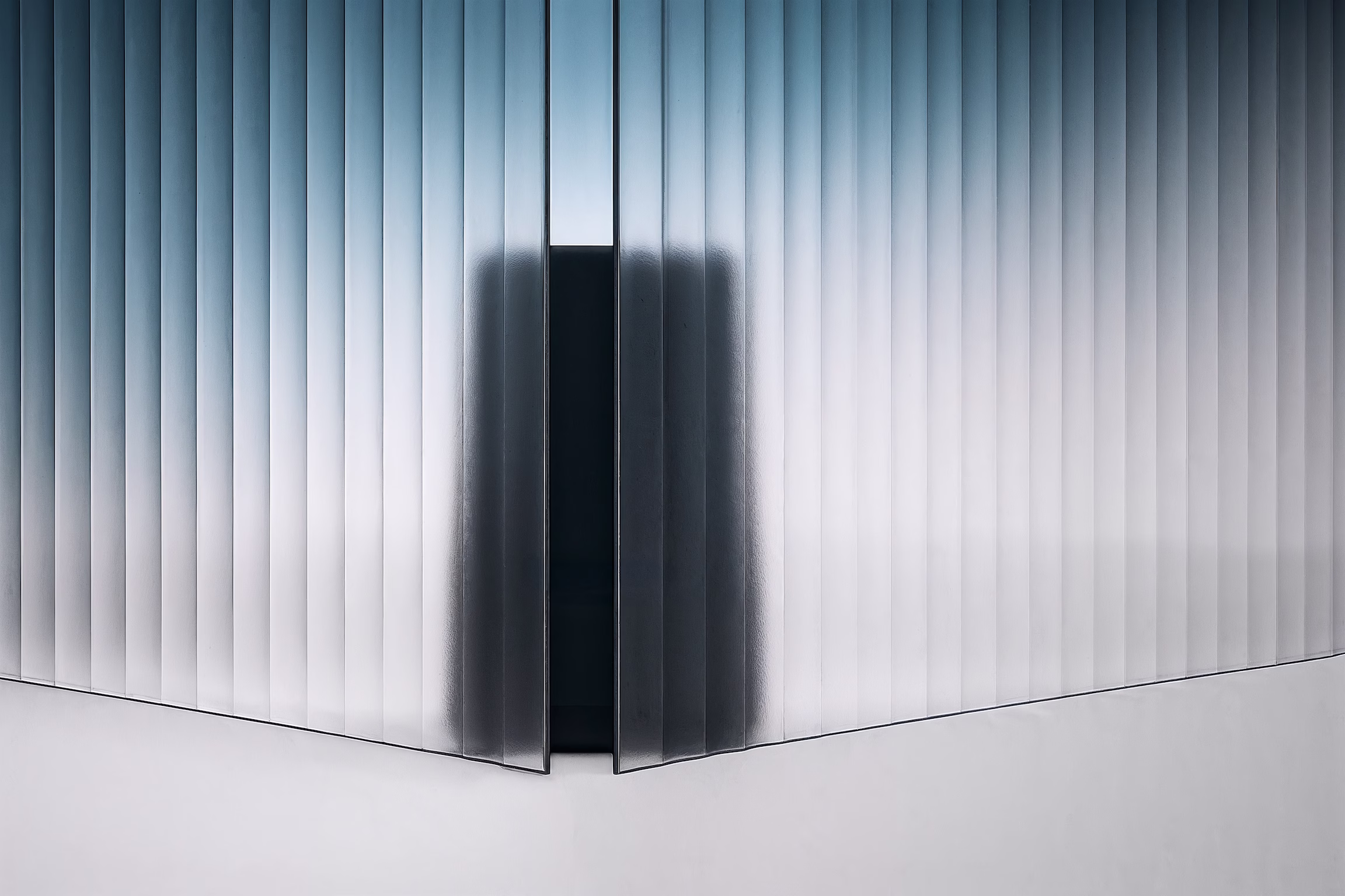 A black product behind a glass wall.