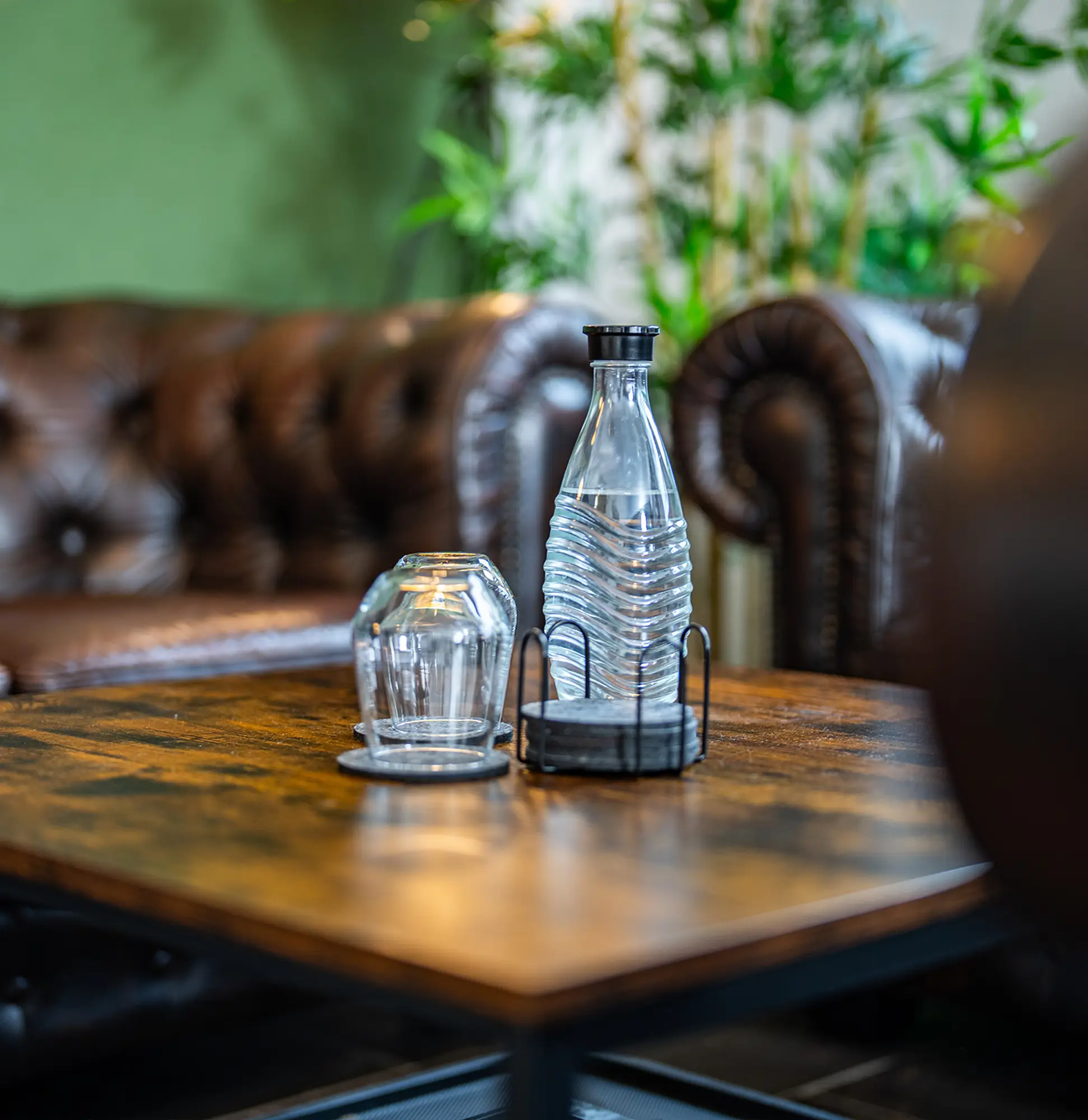 StudioDarmstadt Loungebereich mit Wasserflasche und mehreren Gläsern