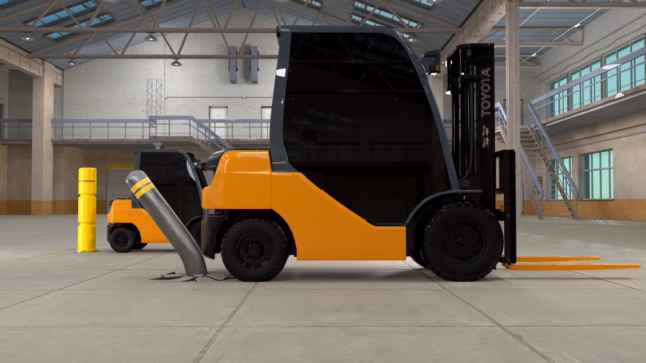 Orange Toyota forklift colliding with a bent metal pipe barrier inside a warehouse.