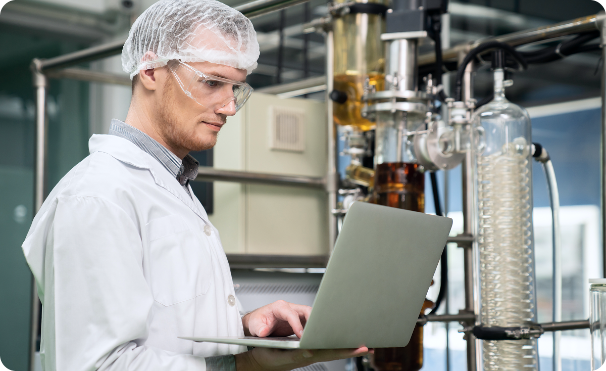 Quality manager reviewing a manual paper compliance chart, illustrating outdated processes before implementing food safety software.