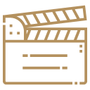 Brown icon of a film clapperboard representing video or movie production.